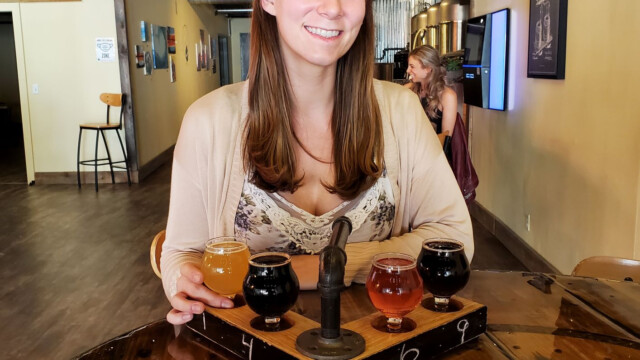 Drinking beer from this awesome flight paddle Melissa at Bye-i Brewing