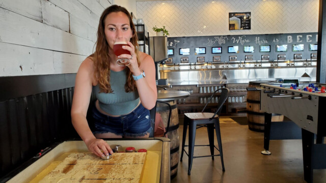 Melissa playing shuffle board at OZ shuffle board