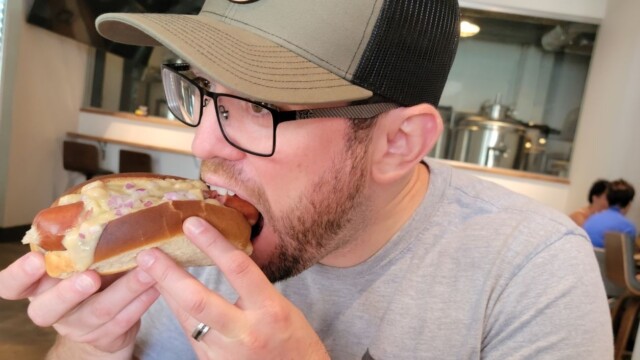 Andrew eating a hot dog at Hop Atomica Andrew hot dog