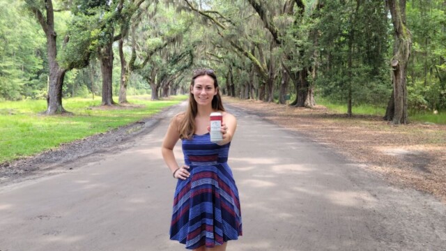 Melissa under the Live Oaks with a can of Side Hustle Beer Co from HHI. Live Oaks