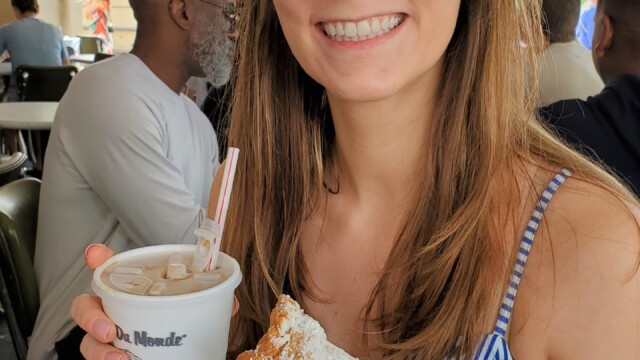 Enjoying a beignet and cafe au lait at Cafe Du Monde cafe du monde
