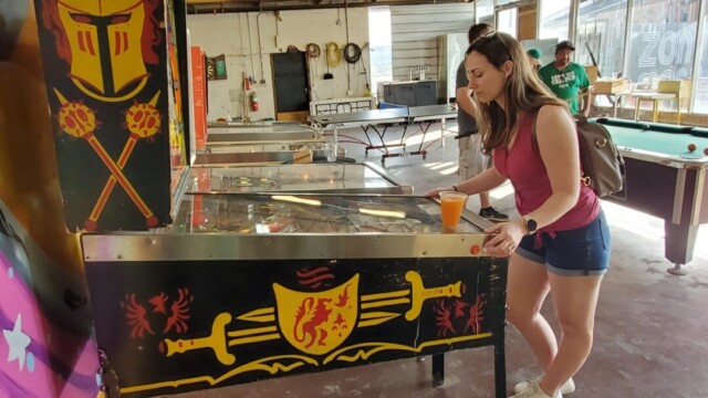 Melissa playing pinball at Zony Mash pinball